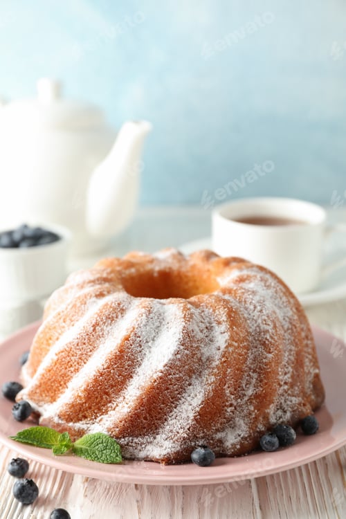 Preview: Cake with powder sugar and blueberry on wooden background, space for text
