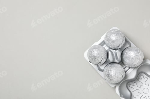 Preview: Foil balls in silver case on light gray background, space for text