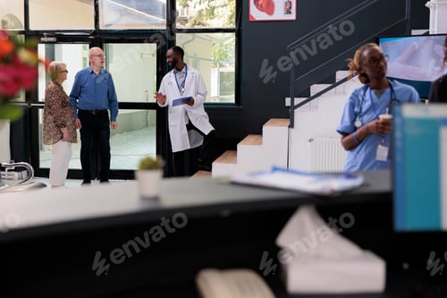 Preview: African american physician explaining health care treatment to elderly couple