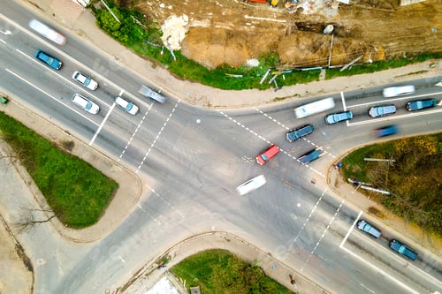 Preview: Top down aerial view of busy street intersection with moving cars traffic