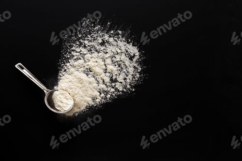 Preview: Flour on black background in measuring spoon