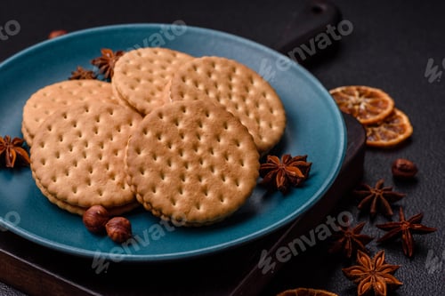 Preview: Round dotted snack snack cookies with cream on a dark concrete background