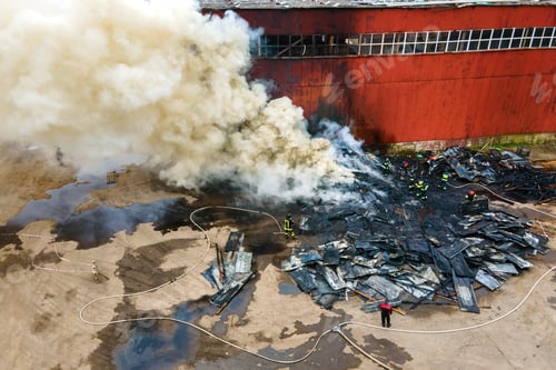 Preview: Aerial view of firemen fighting with fire near old factory biulding in industrial area.