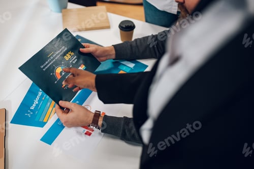Preview: Business colleagues discussing chart document during a meeting