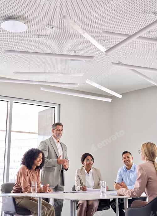 Preview: Happy senior business man ceo working with diverse team at office meeting.