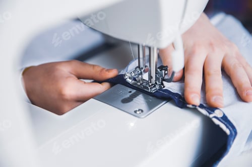 Preview: young girl working with sewing machine