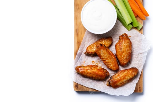Preview: Buffalo spicy chicken wings with cayenne pepper sauce isolated on white background