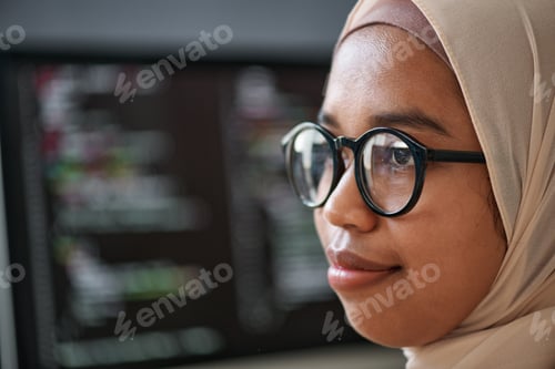 Preview: Close-up of face of young confident Muslim intern in hijab and eyeglasses