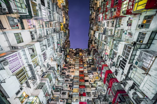 Preview: Low angle shot of tall apartments with a blue sky in the background