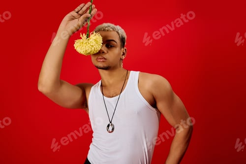Preview: Bold fashion statement from a young man in a striking red studio setting