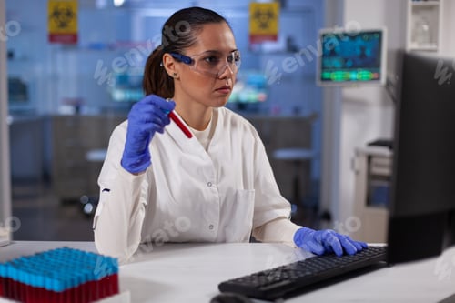 Preview: Scientist woman doctor holding medical vacutainer with blood typing expertise