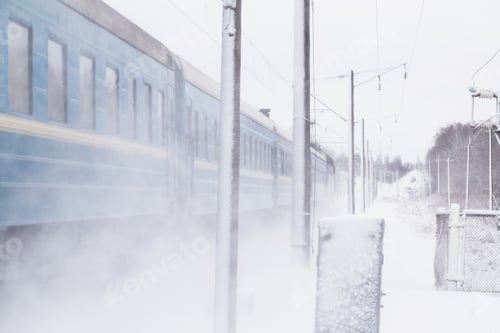 Preview: Passenger train rapidly moving along the snow track