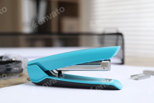 Turquoise Stapler on White Desk in Office
