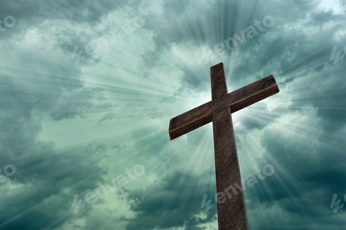 Preview: Religious cross against light rays and parting clouds