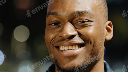 Preview: Male happy portrait african american young millennial satisfied man stands in city in evening town