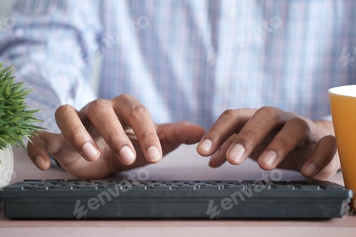 Preview: Close up of man hand typing on keyboard