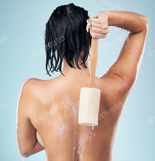 Preview: Shower, back and woman with loofah in studio for body care, wellness and cleaning on blue backgroun