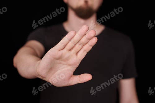 Preview: Man in black t-shirt doing stop sing