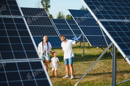 Preview: Happy family near solar panels. Alternative energy source