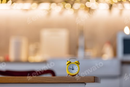 Preview: little alarm clock on a table with Christmas lights
