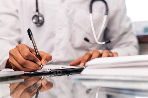 Preview: indian doctor wearing uniform taking notes in medical documents