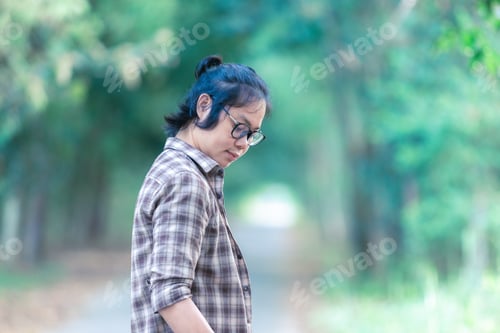 Preview: Pensive Adult Walking Along a Shaded Path