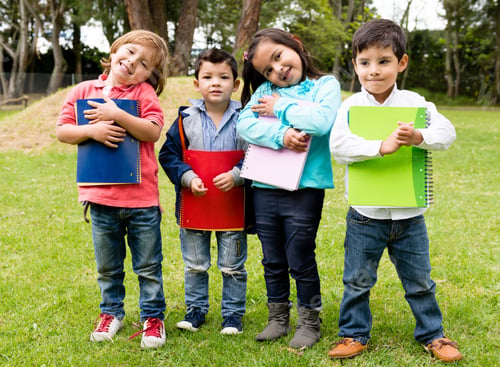 Preview: Happy Group Of School Kids Holding Notebooks Outdoors