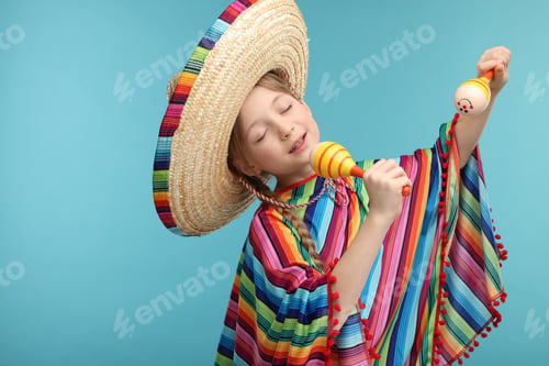 Preview: Cute girl in Mexican sombrero hat and poncho singing with maracas on light blue background