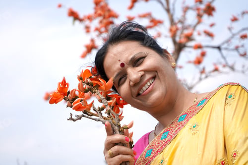 Preview: Portrait of Indian woman with flower in outdoor.