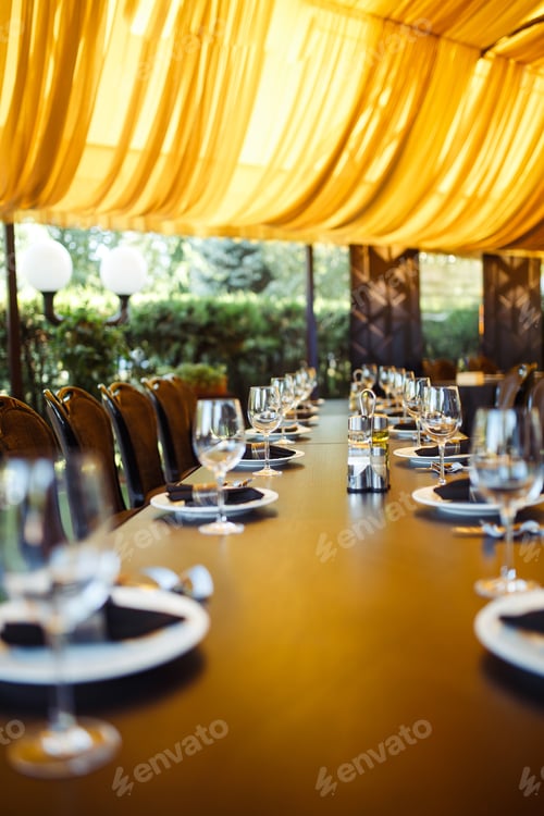Preview: Sparkling glassware stands on long table prepared for wedding dinner.