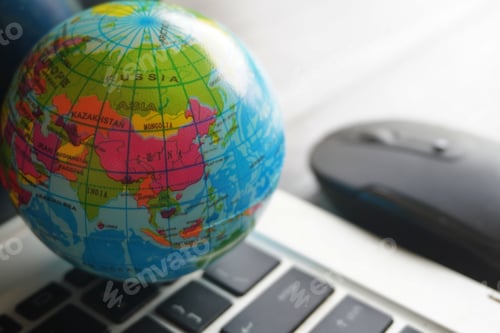 Preview: Close up image of globe, laptop keyboard and computer mouse