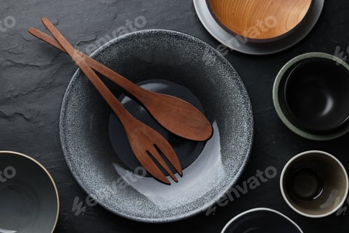 Preview: Set of clean tableware on black table, flat lay