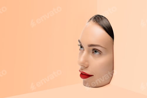 Preview: face of attractive young woman looking away on beige background