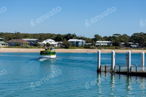Preview: Sandy beach, the ocean and a jetty wharf. Boat ferry on the water