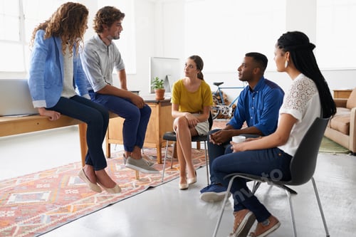 Preview: Working together for better results. Young people chatting in the office.