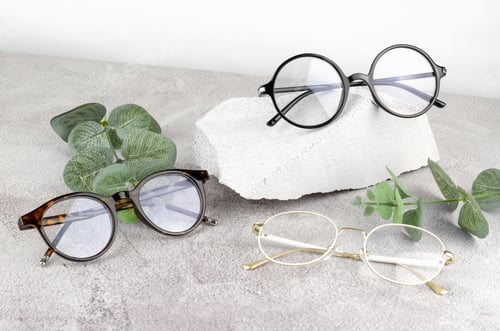 Preview: Glasses for vision of different types on a concrete background.