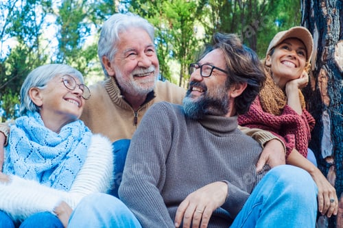 Preview: Happy caucasian family mixed generations fathers and sons have fun together in the outdoors