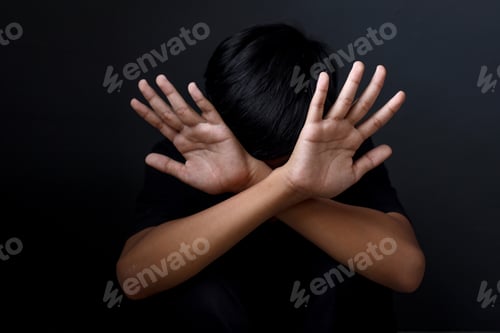 Preview: Kid showing hands doing stop gesture, stopping violence against children.