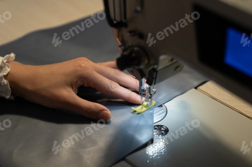 Preview: Seamstress work on sewing machine, closeup. Woman fashion designer create new clothes collection