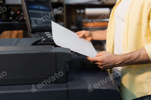Preview: cropped view of publisher holding blank paper in print center
