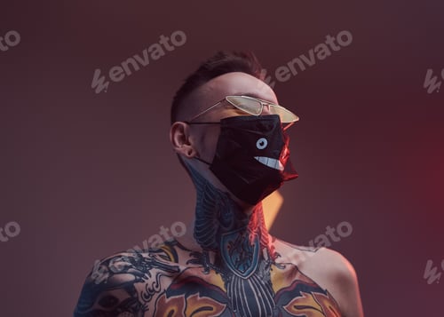 Preview: Topless macho with black mask and sunglasses posing in dark room