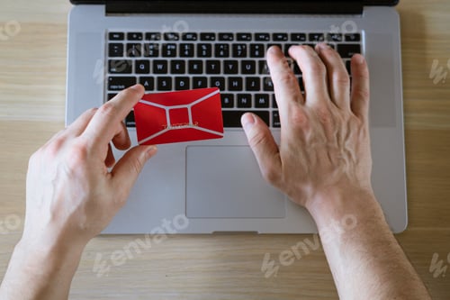 Preview: male hands hold credit card with laptop