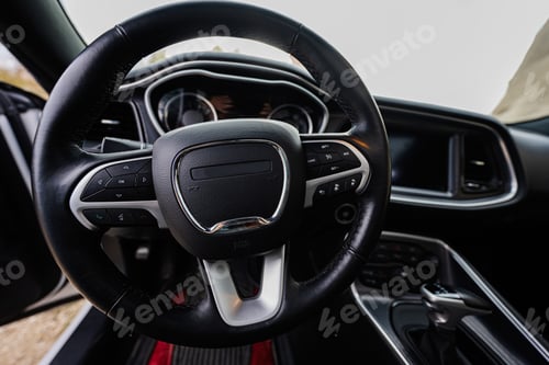 Preview: Interior of the muscle car. Steering wheel in black salon.