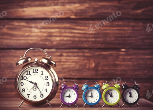 Preview: Retro alarm clocks on a table. Photo in retro color image style