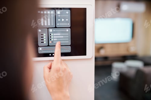 Preview: Hand of young woman touching one of digital buttons on smart remote control