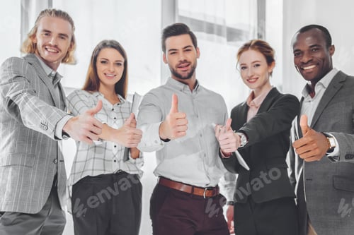 Preview: smiling multicultural businesspeople showing thumbs up