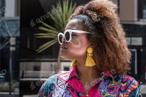 Preview: Fashionable ethnic woman standing on street