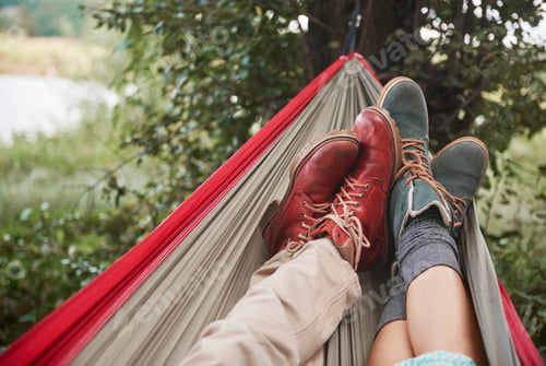 Preview: Feet of couple relaxing in hammock, Krakow, Malopolskie, Poland, Europe