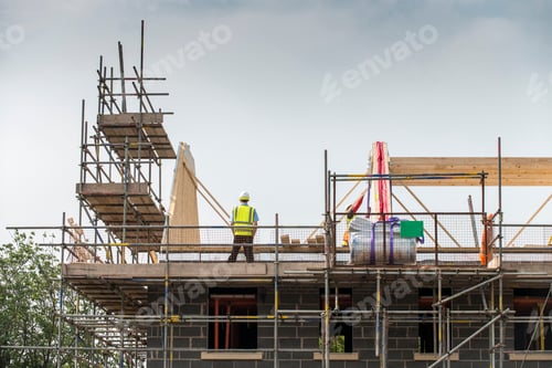 Preview: Worker working on roof of building
