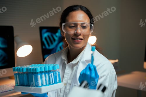 Preview: Woman scientist holding test tubes for genetic research